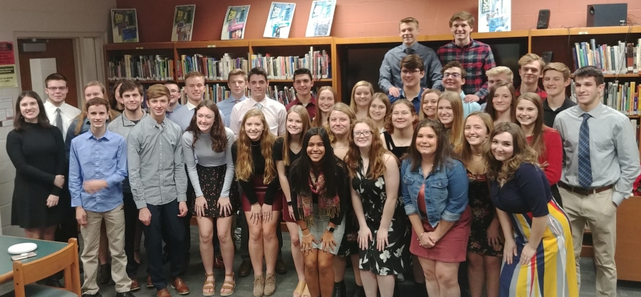 lots of people posing in a library